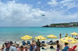 Small aircraft approaching over Maho to land at St Martin Airport.jpg