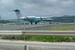 Airplane behind barbed wire fence of Princess Juliana International Airport viewed from Maho Beach.jpg