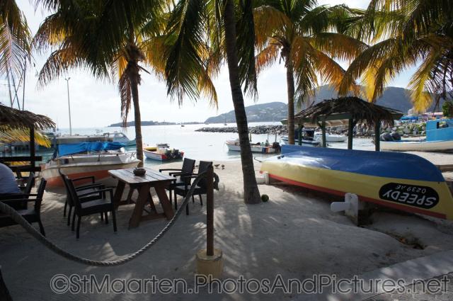 Palm trees and canoe oceanside in downtown Philipsburg St Maarten.jpg