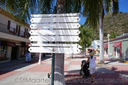 Direction signs in St Maarten cruise terminal plaza.jpg