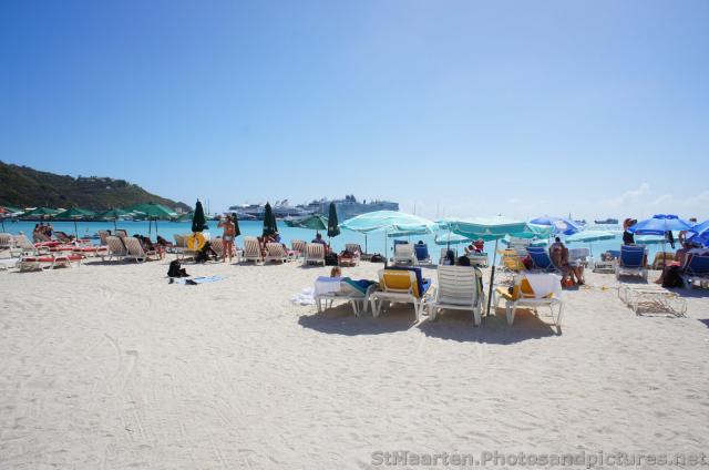 Tourists enjoying beach at Philipsburg St Maarten with cruise ships seen in the distance.jpg
