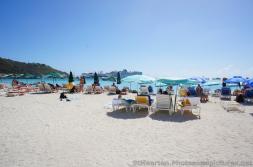 Tourists enjoying beach at Philipsburg St Maarten with cruise ships seen in the distance.jpg