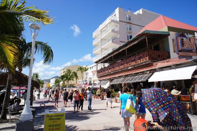 Tourists walking beach-side boardwalk of Philipsburg St Maarten.jpg