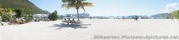 Panoramic photo of beginning of beach area and 5 cruise ships docked in the distance in Philipsburg St Maarten.jpg
