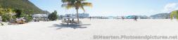 Panoramic photo of beginning of beach area and 5 cruise ships docked in the distance in Philipsburg St Maarten.jpg