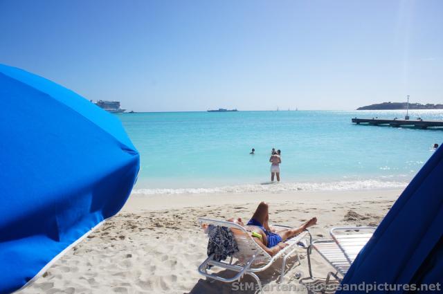 View of the ocean past beach umbrellas in Philipsburg St Maarten.jpg