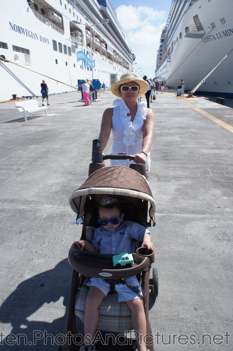Darwin in a stroller with Mommy pushing at St Maarten next to two cruise ships.jpg
