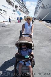 Darwin in a stroller with Mommy pushing at St Maarten next to two cruise ships.jpg
